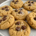 Best peanut butter cookies served with a glass of milk and garnished with chocolate drizzle.